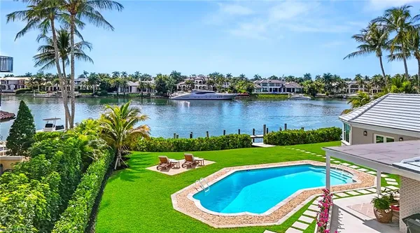 a view of a lake with a house and a garden