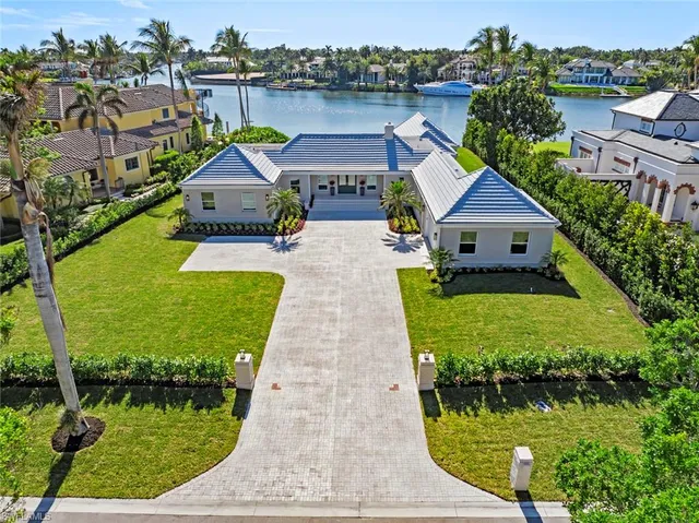 aerial view of a house with swimming pool and lake view
