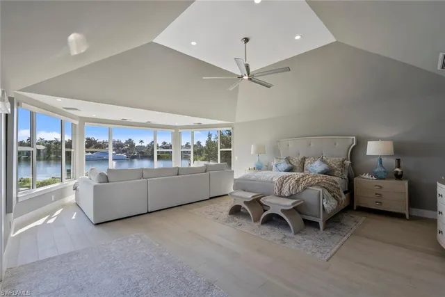 a living room with furniture and a floor to ceiling window