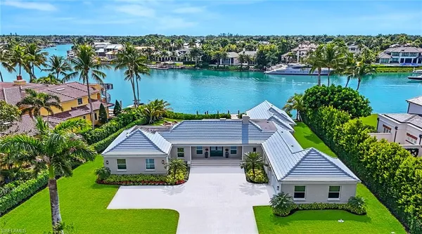 an aerial view of a house with a garden and a lake view