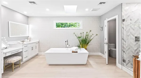 a bunch of flowers are in front of a house