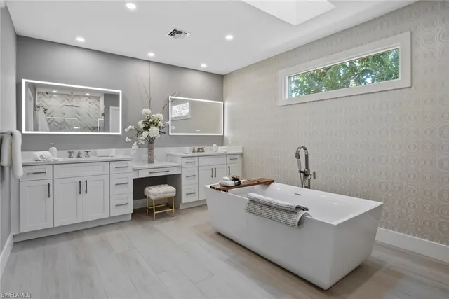 a living room with furniture and painting on the wall