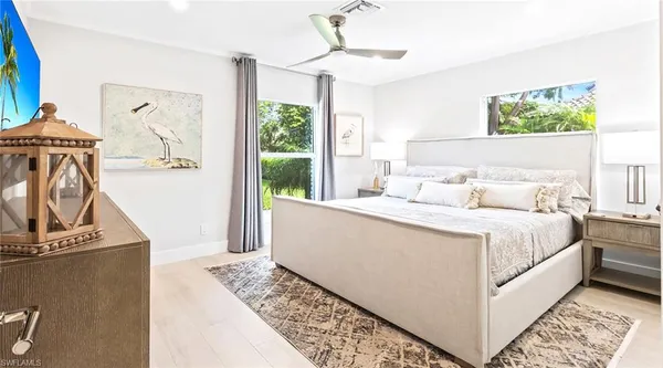 a front view of a house with a garden and plants