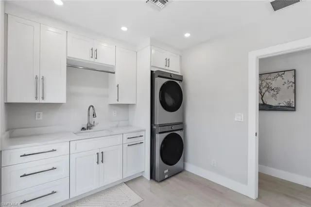 a kitchen with a stove top oven sink and cabinets
