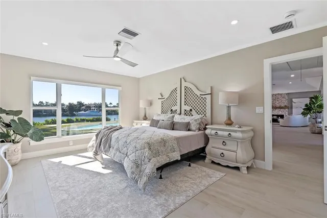 a bed room with a bed and a large window