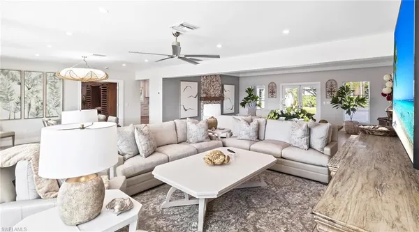 a large white kitchen with cabinets and wooden floor