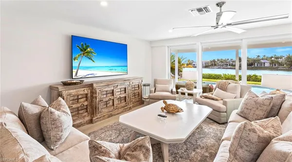 a kitchen with kitchen island a dining table and chairs