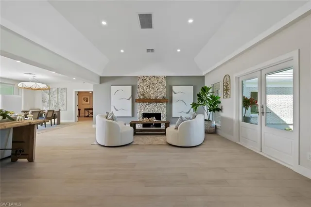 a room with a couch and potted plant