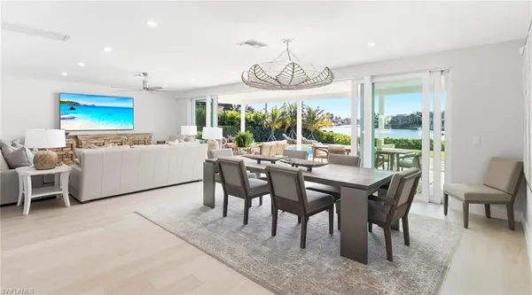 a living room with furniture a window and a potted plant