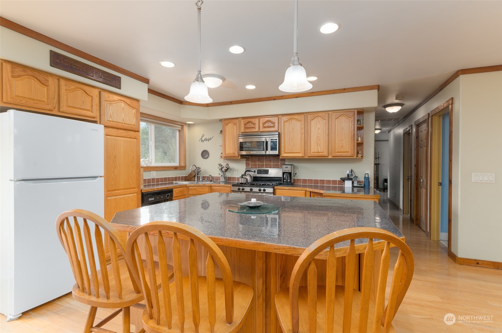 8170 North Telegraph Road Everson, WA 98247 - Photo 14 of 40 a kitchen with stainless steel appliances granite countertop a refrigerator a stove top oven a sink dishwasher and white cabinets with wooden floor