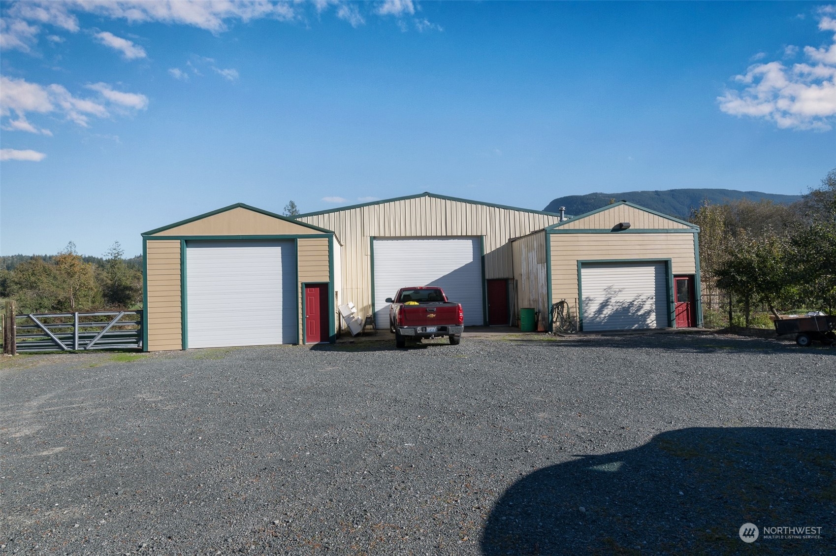 8170 North Telegraph Road Everson, WA 98247 - Photo 6 of 40 a view of a house with a large space and a car parked in it
