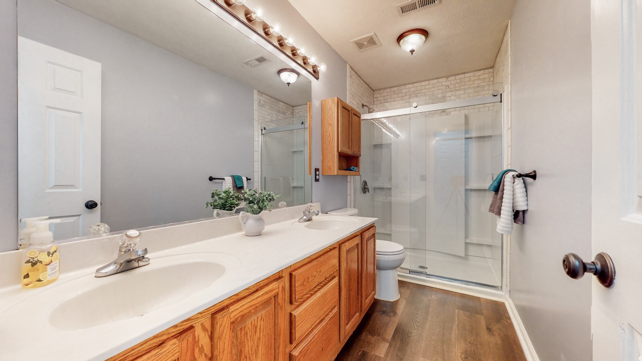 2114 Clara Mathis Road Spring Hill, TN 37174 - Photo 14 of 62 a spacious bathroom with a double vanity sink a mirror and a shower