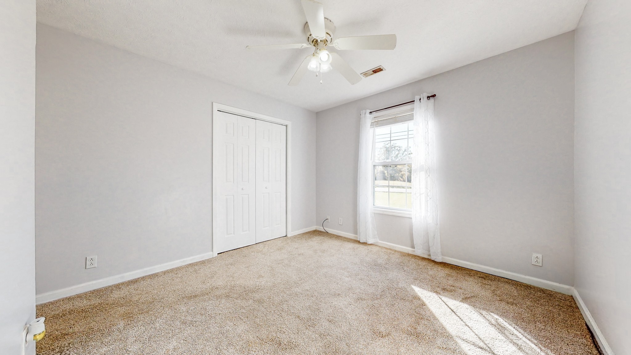 2114 Clara Mathis Road Spring Hill, TN 37174 - Photo 17 of 62 an empty room with chandelier fan and windows
