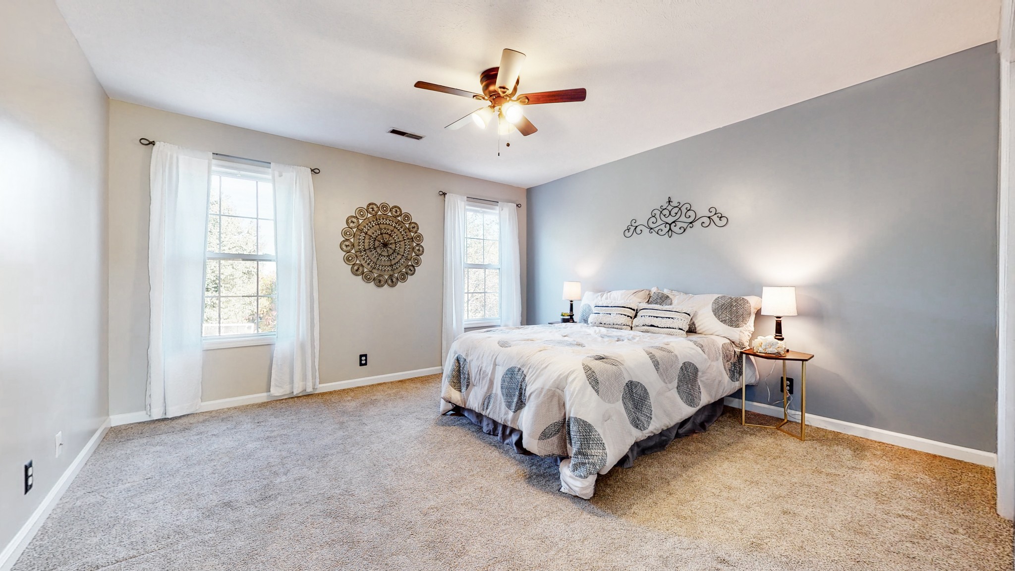 2114 Clara Mathis Road Spring Hill, TN 37174 - Photo 21 of 62 a spacious bedroom with a bed and a ceiling fan
