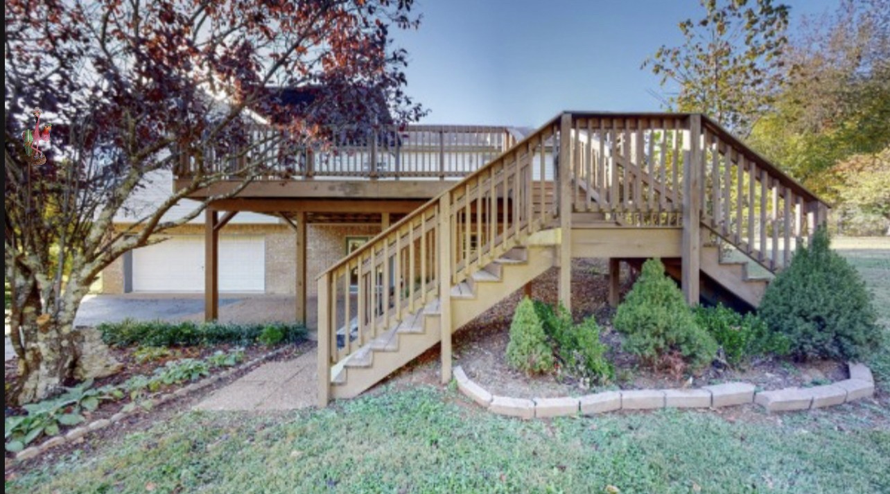 2114 Clara Mathis Road Spring Hill, TN 37174 - Photo 45 of 62 a view of a house with brick walls and flower plants with wooden fence