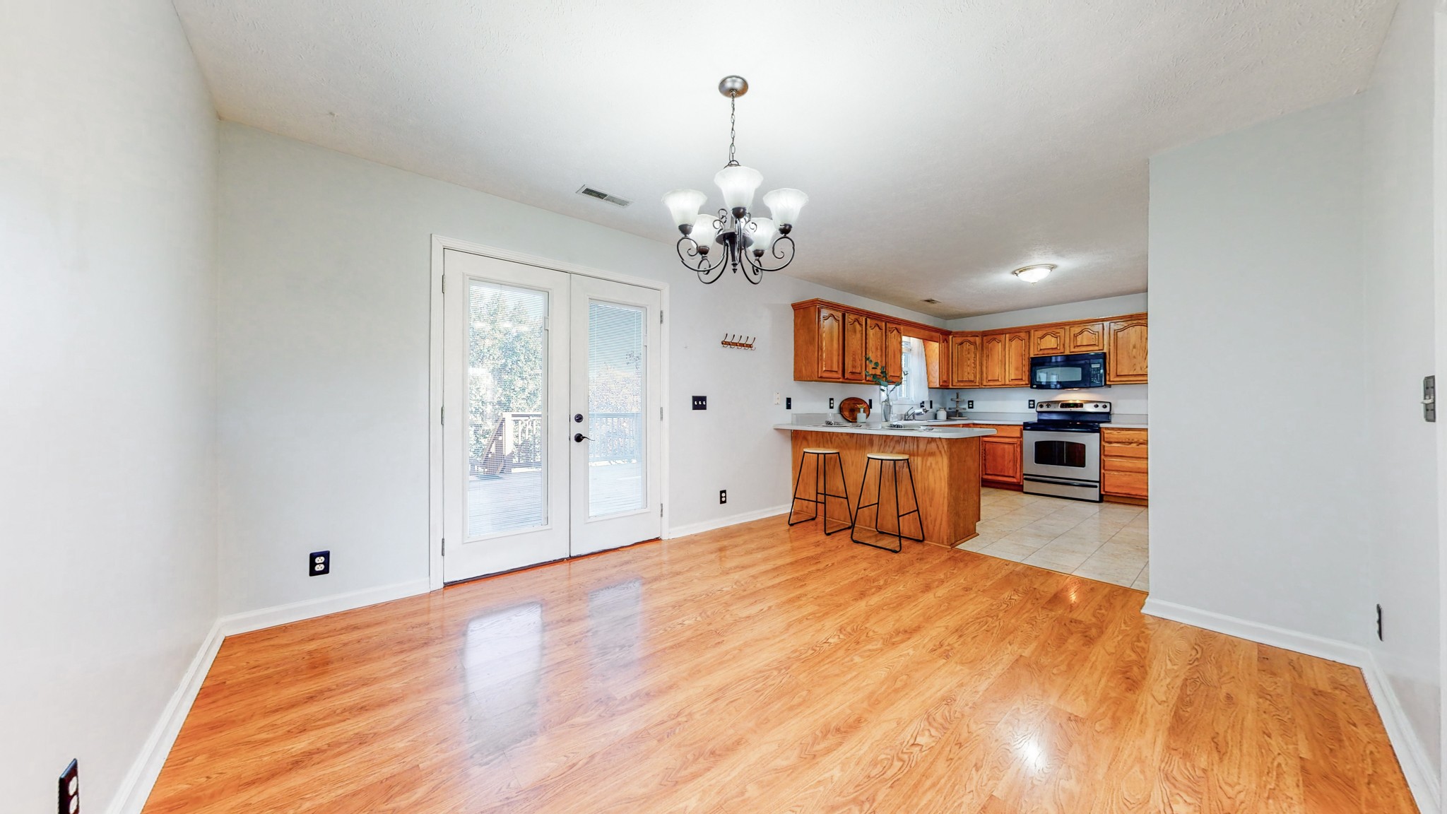 2114 Clara Mathis Road Spring Hill, TN 37174 - Photo 8 of 62 a kitchen with stainless steel appliances kitchen island granite countertop a refrigerator a stove a sink dishwasher and white cabinets with wooden floor