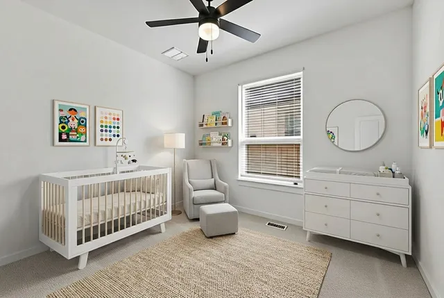 a bedroom with a bed window and a dresser