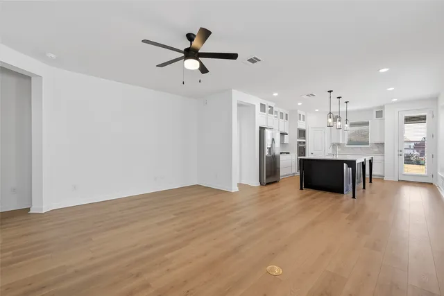 a view of a kitchen with a sink stainless steel appliances and cabinets