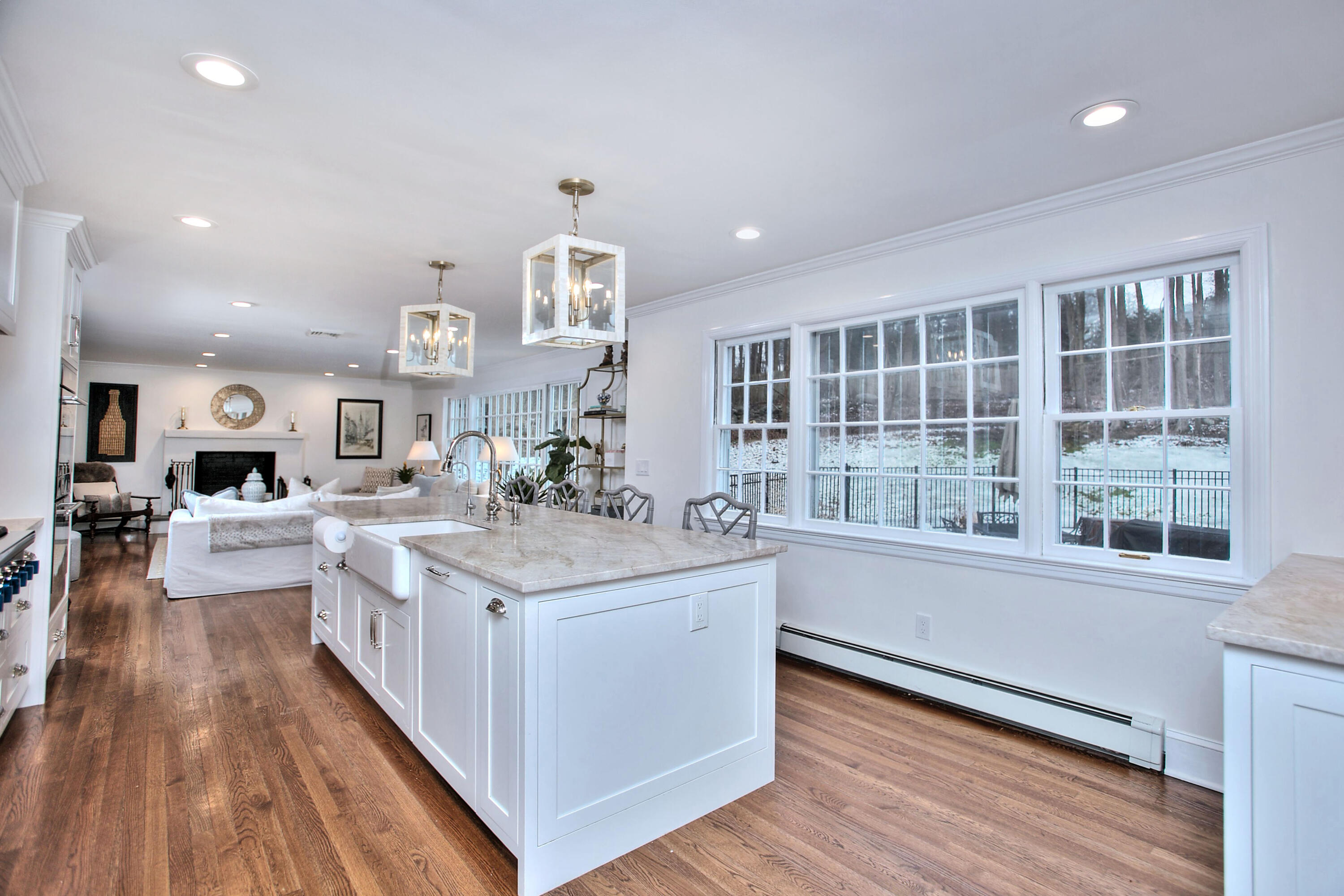 45 Beech Road New Canaan, CT 06840 - Photo 12 of 37 a large white kitchen with stainless steel appliances granite countertop a lot of counter space and wooden floors