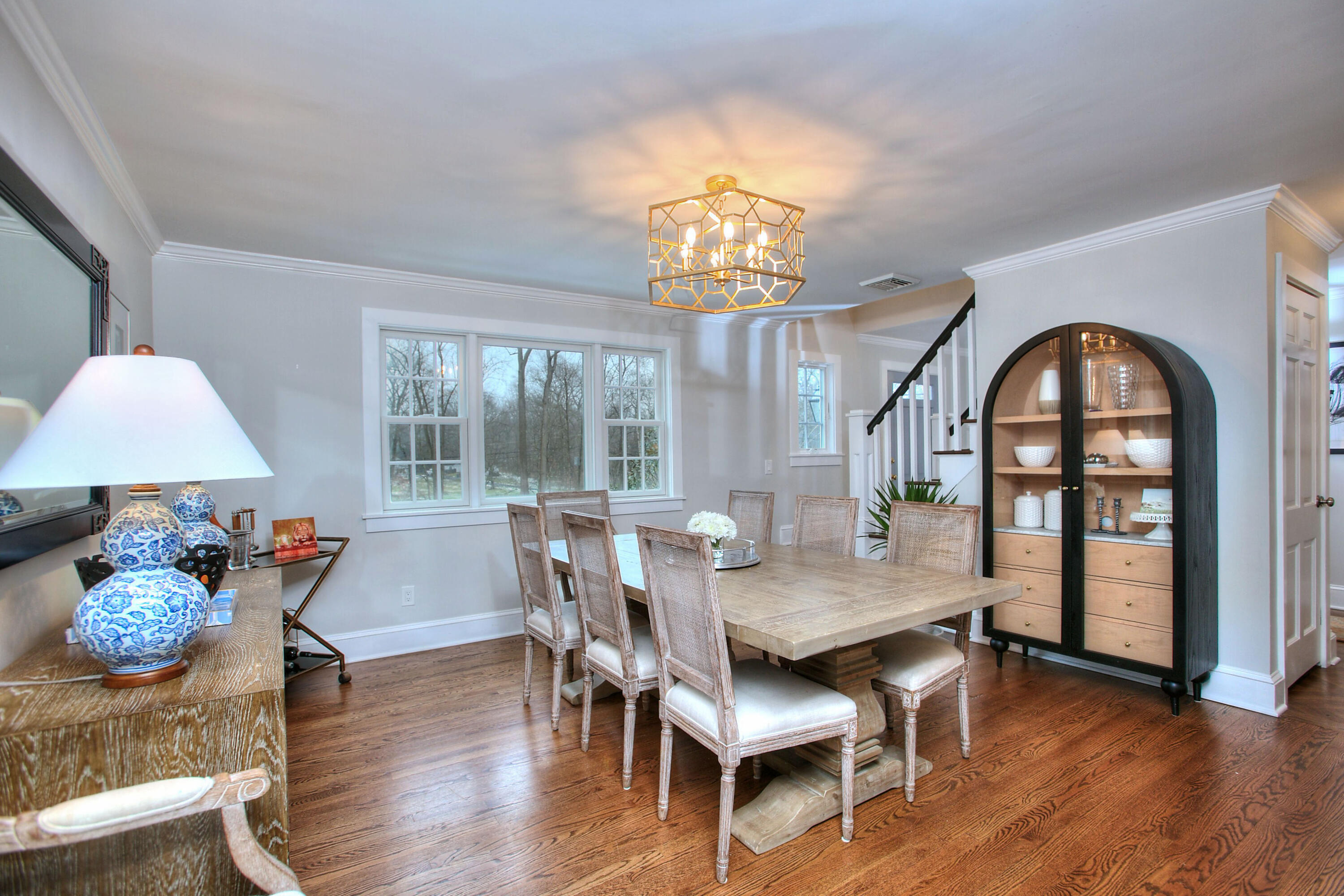 45 Beech Road New Canaan, CT 06840 - Photo 13 of 37 a view of a dining room with furniture a chandelier and wooden floor