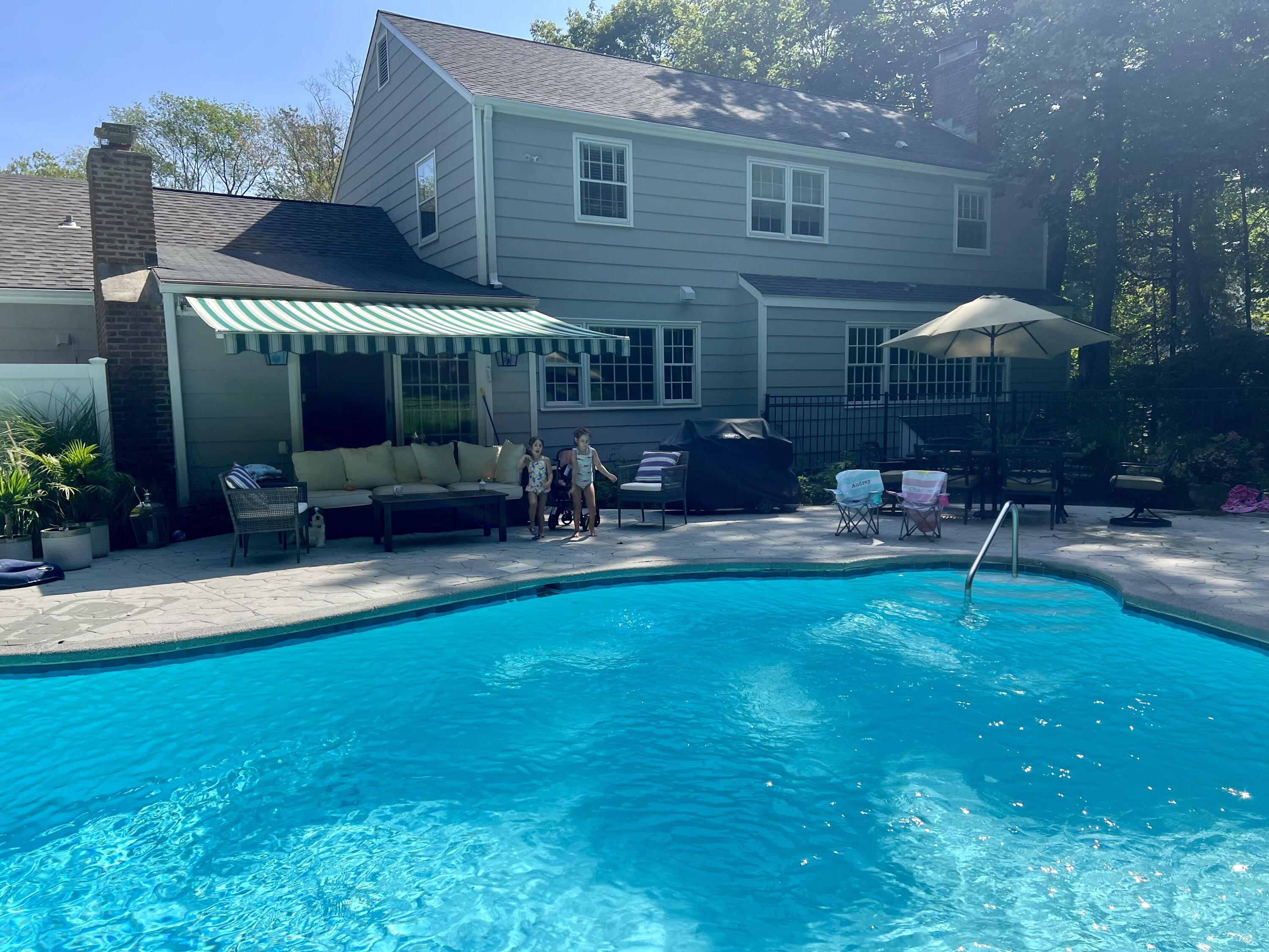 45 Beech Road New Canaan, CT 06840 - Photo 2 of 37 a backyard of a house with table and chairs