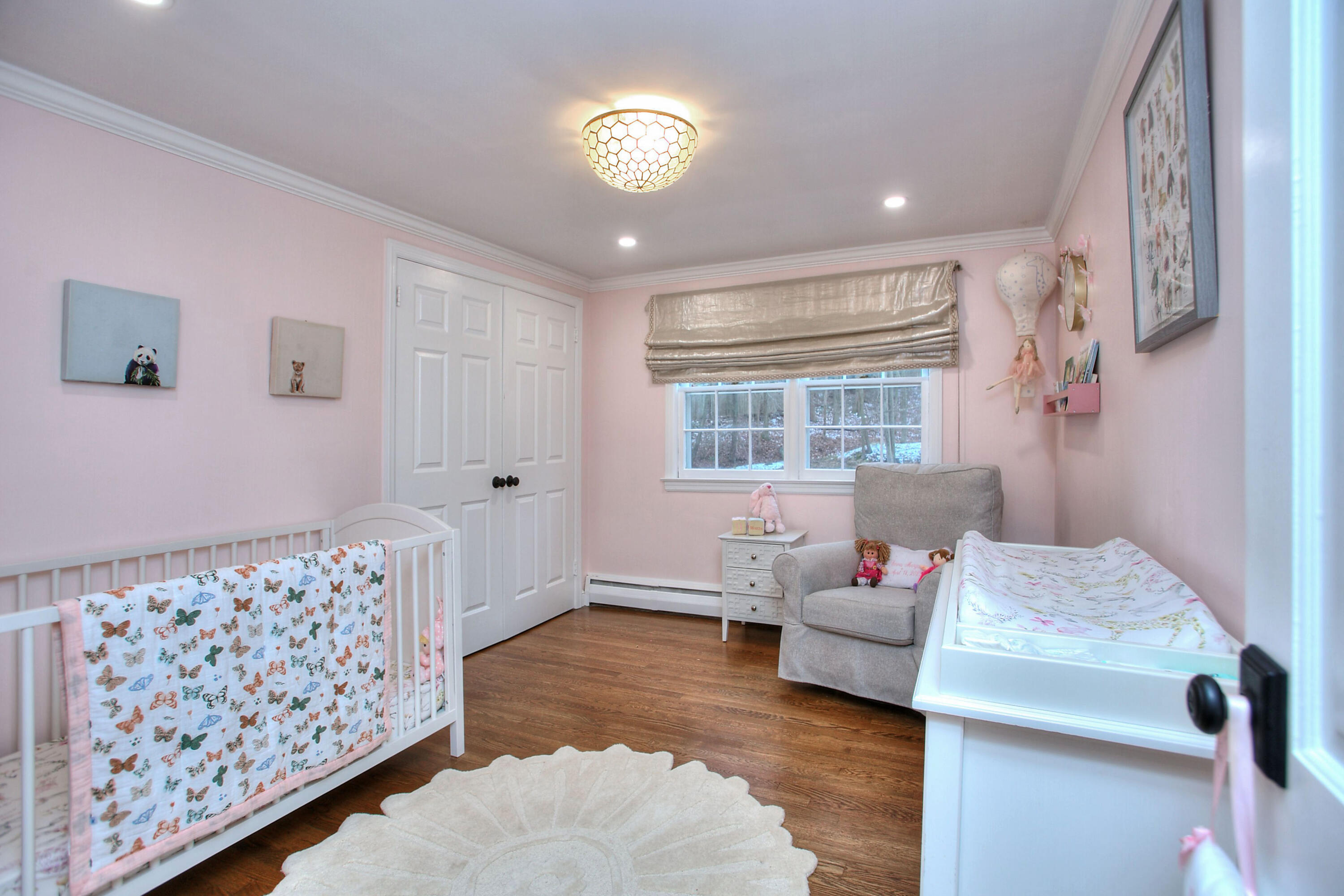 45 Beech Road New Canaan, CT 06840 - Photo 27 of 37 a bedroom with furniture and a chandelier