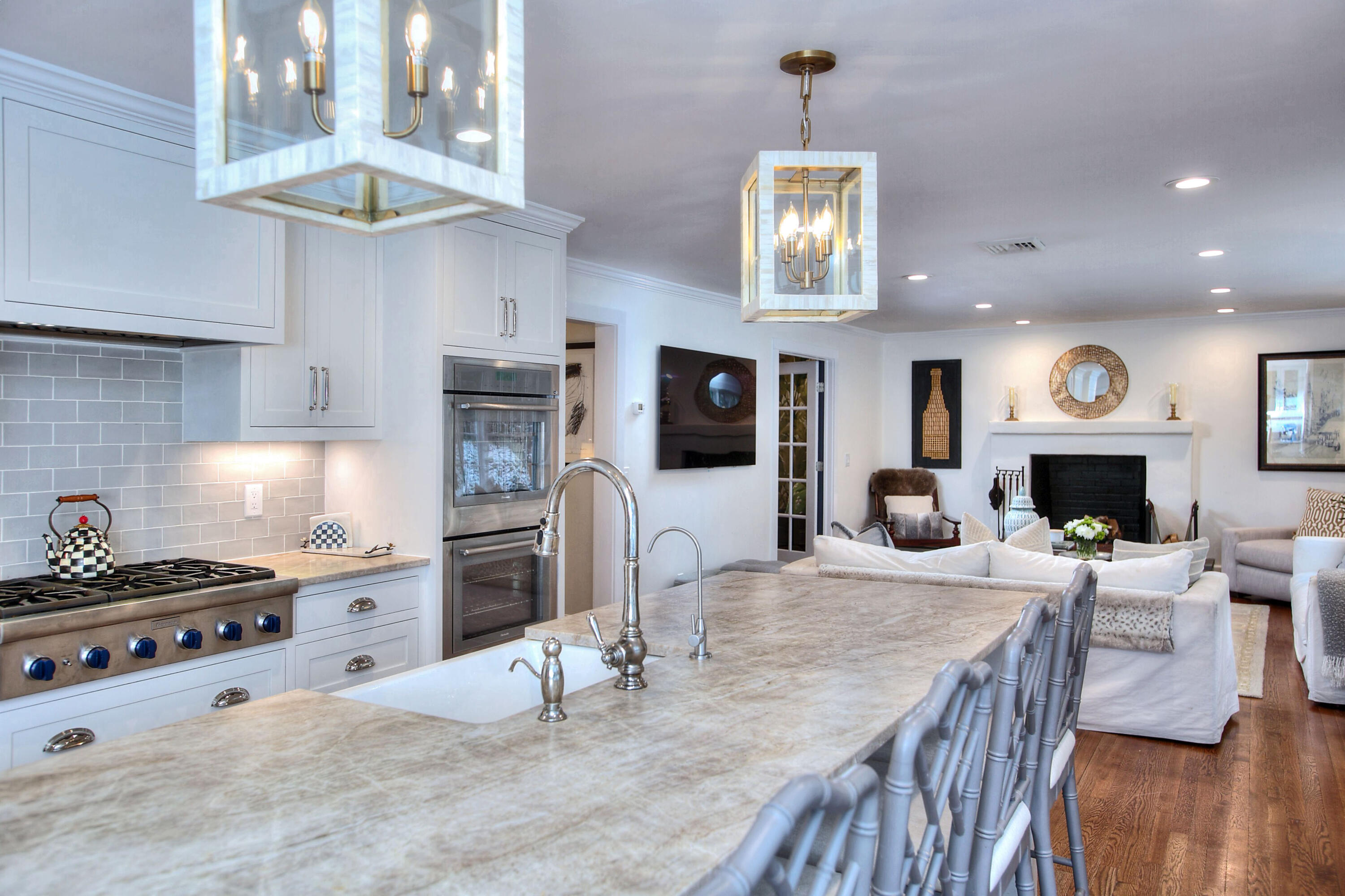45 Beech Road New Canaan, CT 06840 - Photo 10 of 37 a kitchen with stainless steel appliances granite countertop a stove top oven a refrigerator a sink dishwasher a dining table and chairs with wooden floor