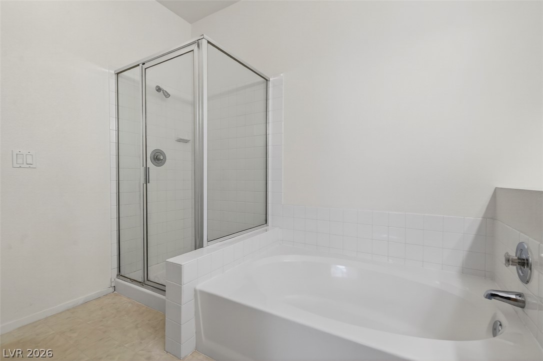 2201 Ramsgate Drive, Unit 1011 Henderson, NV 89074 - Photo 22 of 40 An immaculate primary bath features a spacious soaking tub and a dedicated walk-in shower.