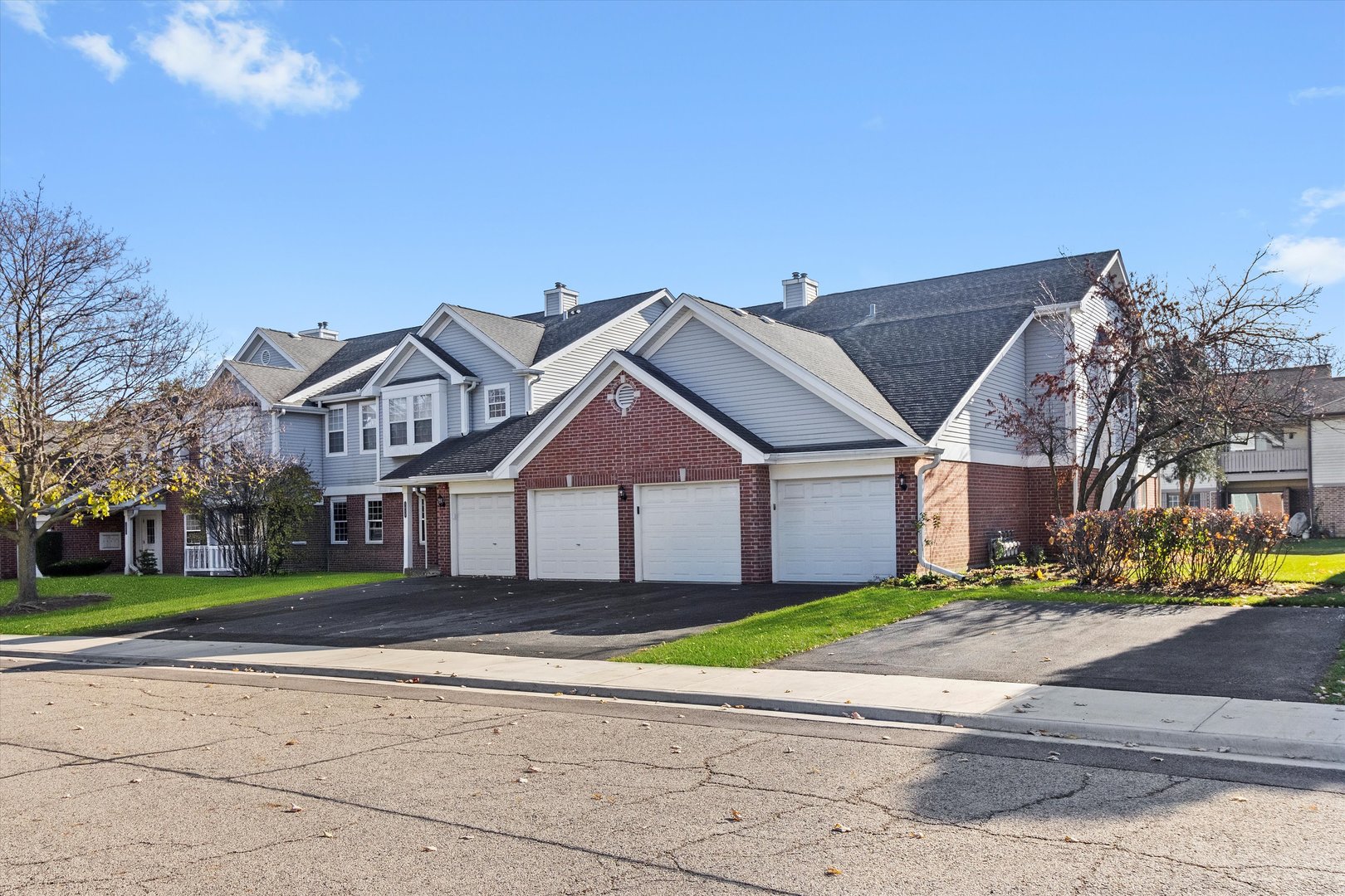 a view of a big house with a big yard and large trees