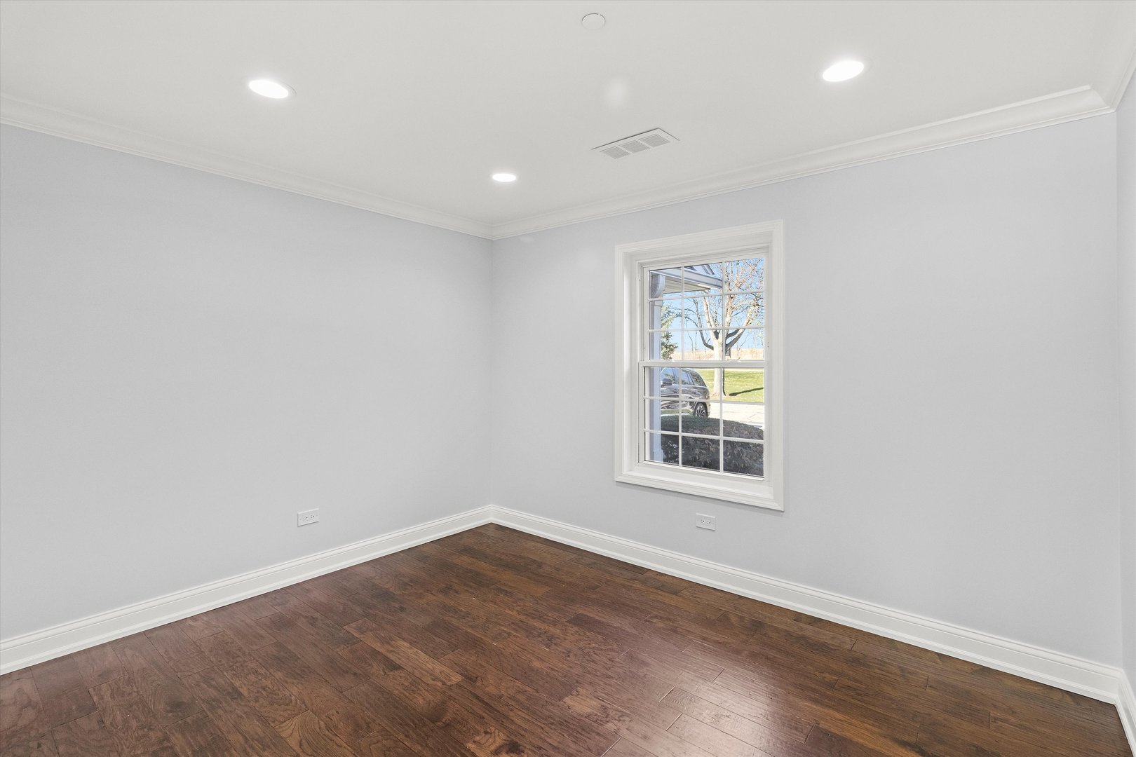 1615 West Hawkes Street, Unit 5 Arlington Heights, IL 60004 - Photo 11 of 17 an empty room with wooden floor and windows