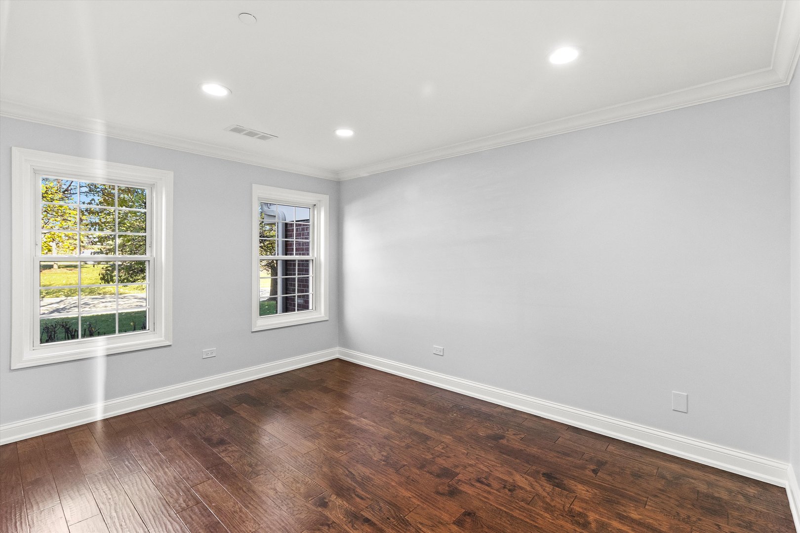 1615 West Hawkes Street, Unit 5 Arlington Heights, IL 60004 - Photo 14 of 17 an empty room with wooden floor and windows