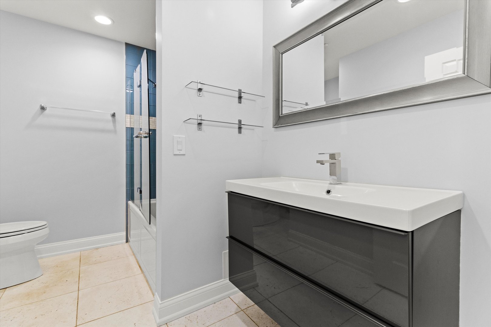 1615 West Hawkes Street, Unit 5 Arlington Heights, IL 60004 - Photo 16 of 17 a bathroom with a sink a toilet and shower