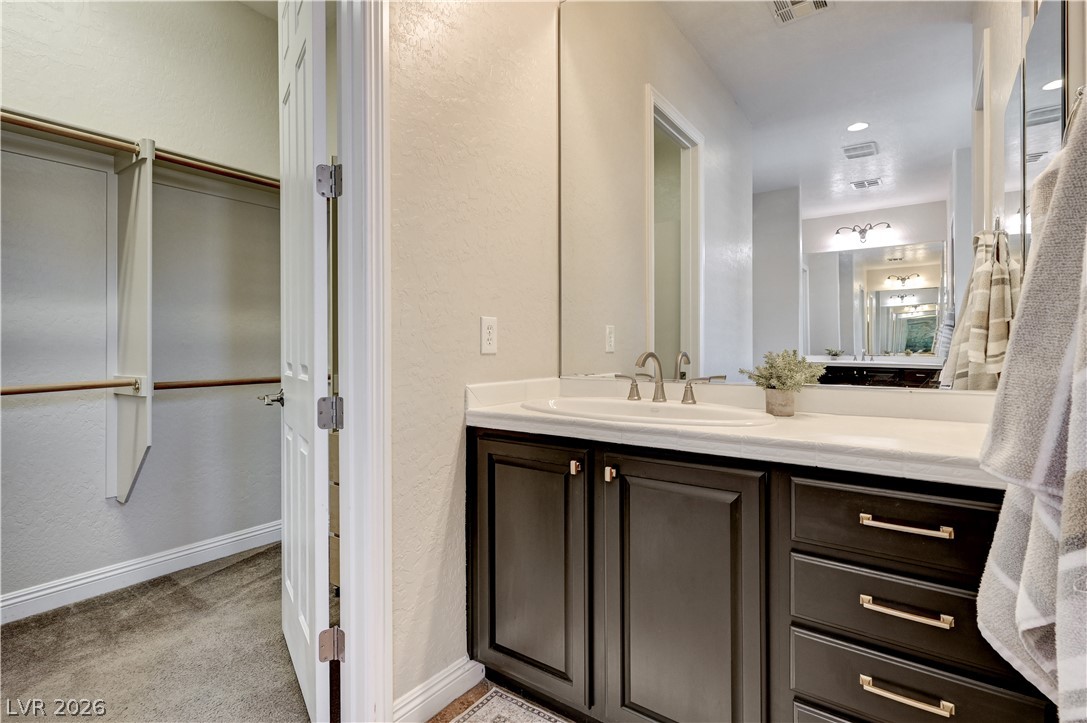 2793 Rosenhearty Drive Henderson, NV 89044 - Photo 44 of 77 Ample storage space and convenient vanity sink combine for a functional and inviting bathroom.