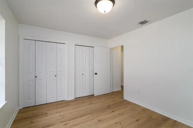 a view of room with wooden floor