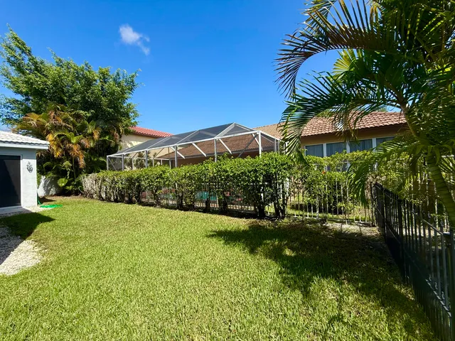a front view of a house with a garden and plants