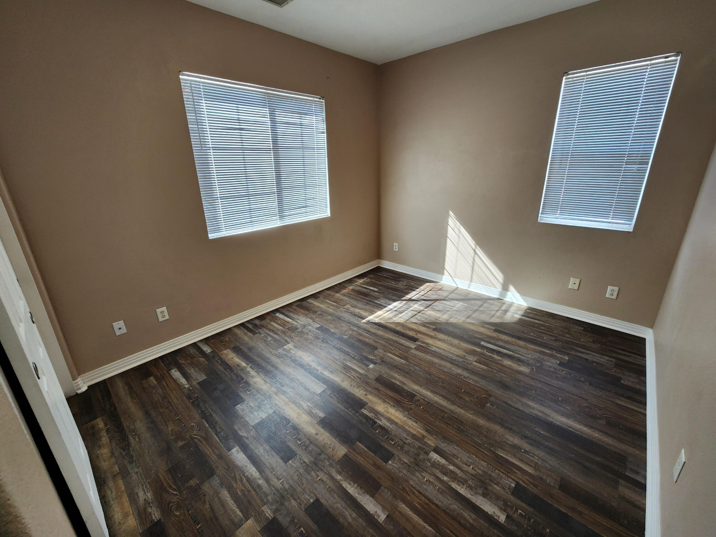 84476 Ruebens Way Coachella, CA 92236 - Photo 18 of 47 a view of an empty room with wooden floor and a window