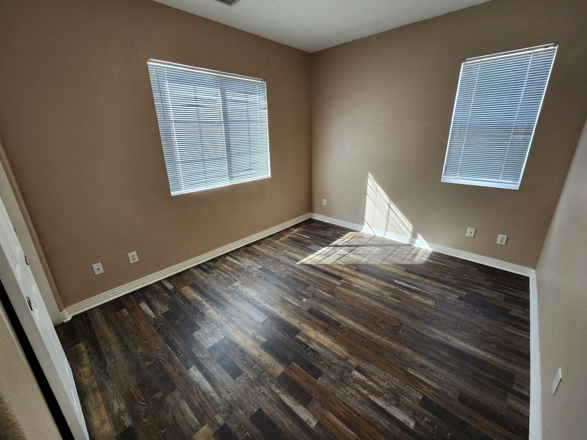 84476 Ruebens Way Coachella, CA 92236 - Photo 27 of 47 a view of an empty room with wooden floor and a window