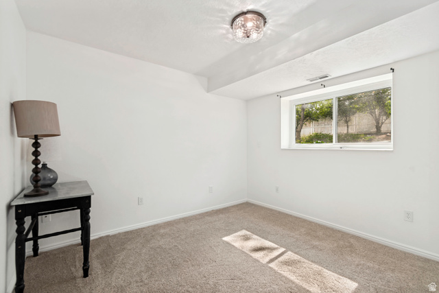 332 East Magellan Lane Elk Ridge, UT 84651 - Photo 19 of 24 Carpeted room featuring a white ceiling and walls, a rectangular window, and a built-in ceiling light fixture