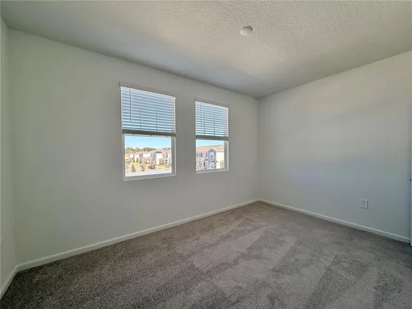 a bathroom with a granite countertop sink a toilet and a mirror