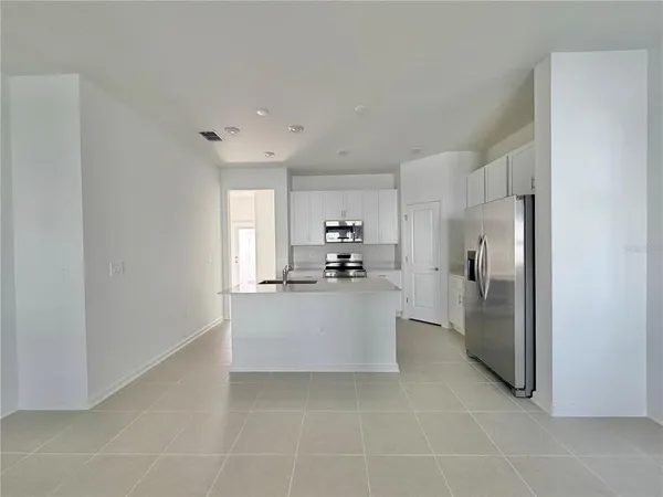 a view of kitchen with refrigerator sink and microwave