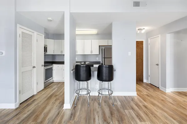 a view of an empty room with wooden floor