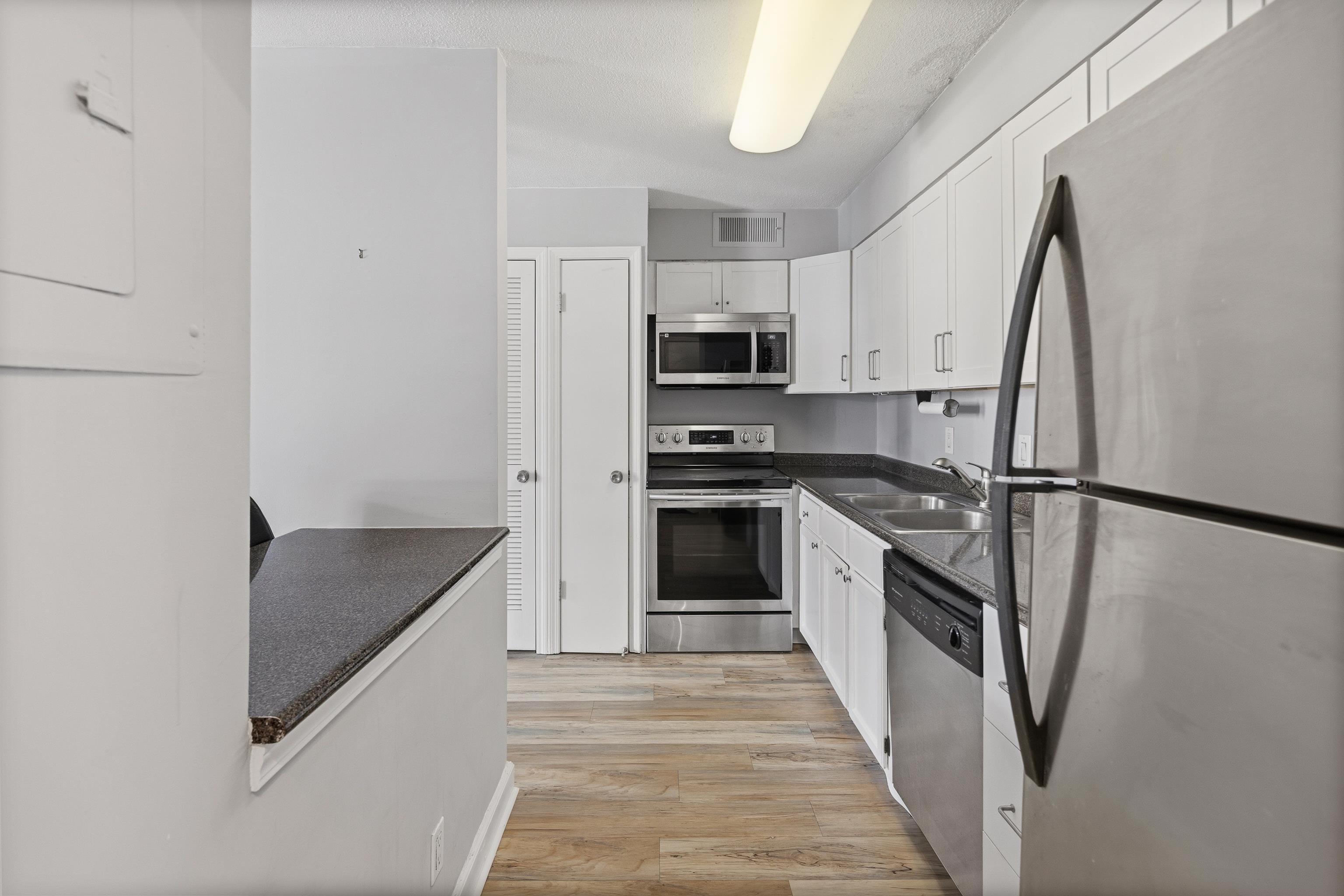 109 North Main Street, Unit 412 Memphis, TN 38103 - Photo 11 of 35 a kitchen with stainless steel appliances granite countertop a refrigerator a stove a sink and dishwasher