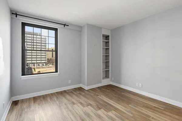 a bedroom with furniture and a window