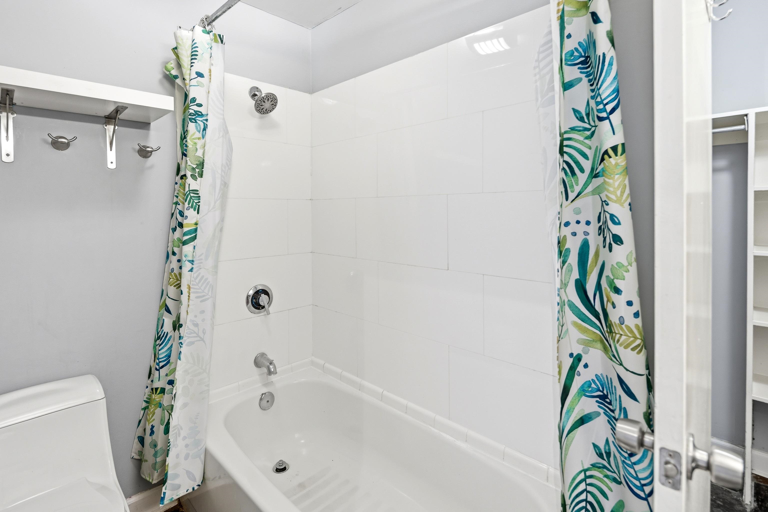 109 North Main Street, Unit 412 Memphis, TN 38103 - Photo 16 of 35 a bathroom with a bathtub and a shower