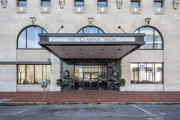 a kitchen with granite countertop white cabinets and black appliances
