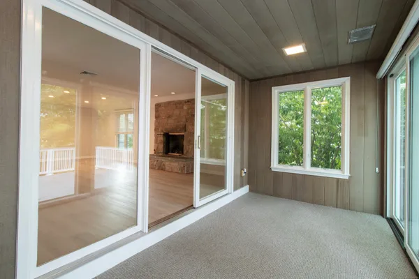 a view of a hallway with large windows