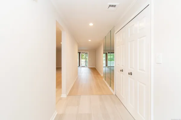a view of a hallway with wooden floor