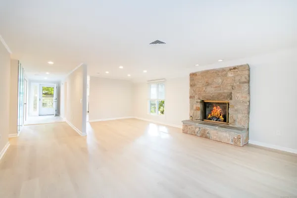 a view of an empty room with a fireplace