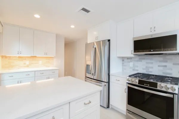 a kitchen with a sink and large window