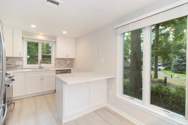 a kitchen with a refrigerator a stove a sink and a oven